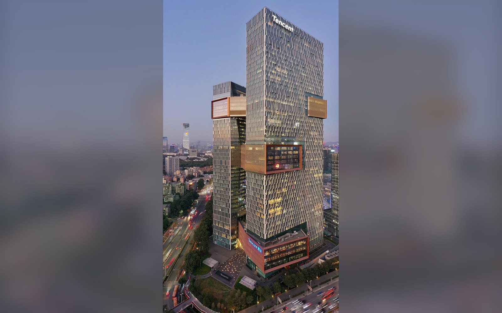Tencent's headquarters skyscraper towers over the city skyline at dusk