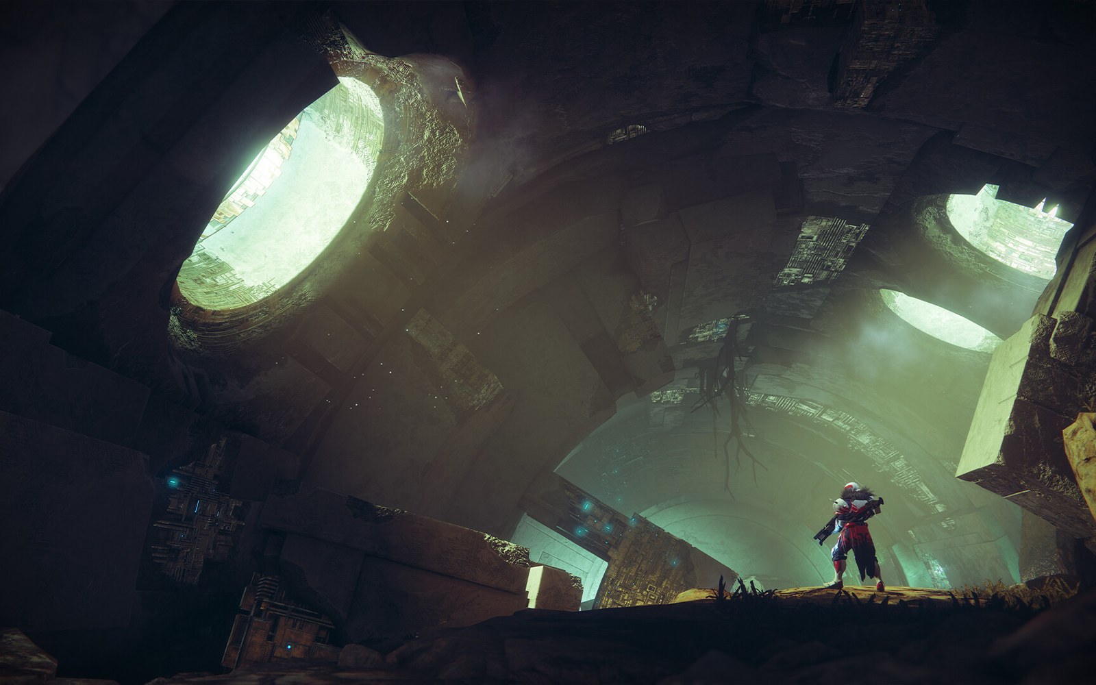 A lone armored character stands in a cavernous ruin lit by glowing circular skylights