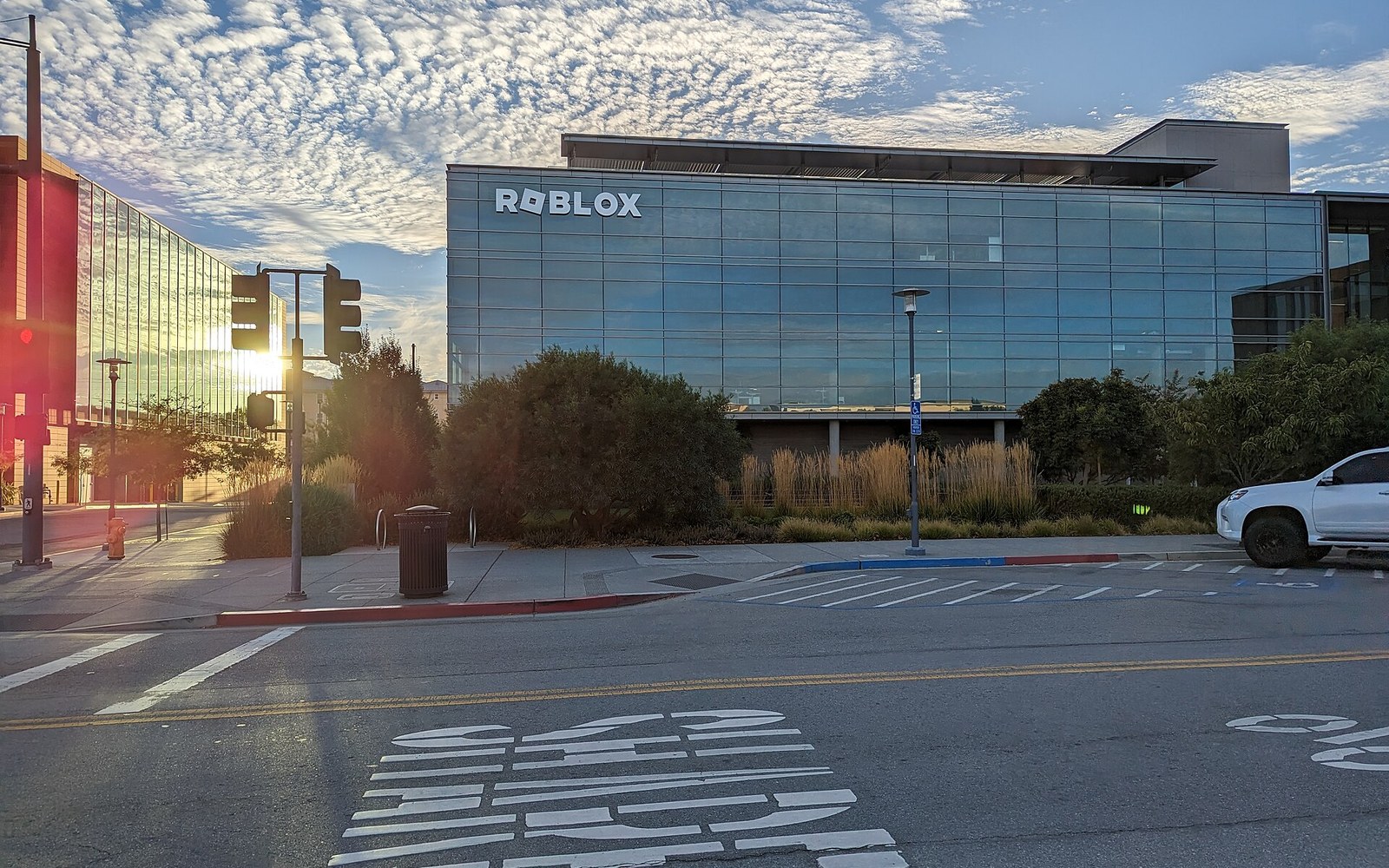 Roblox headquarters building with glass facade and signage at sunrise