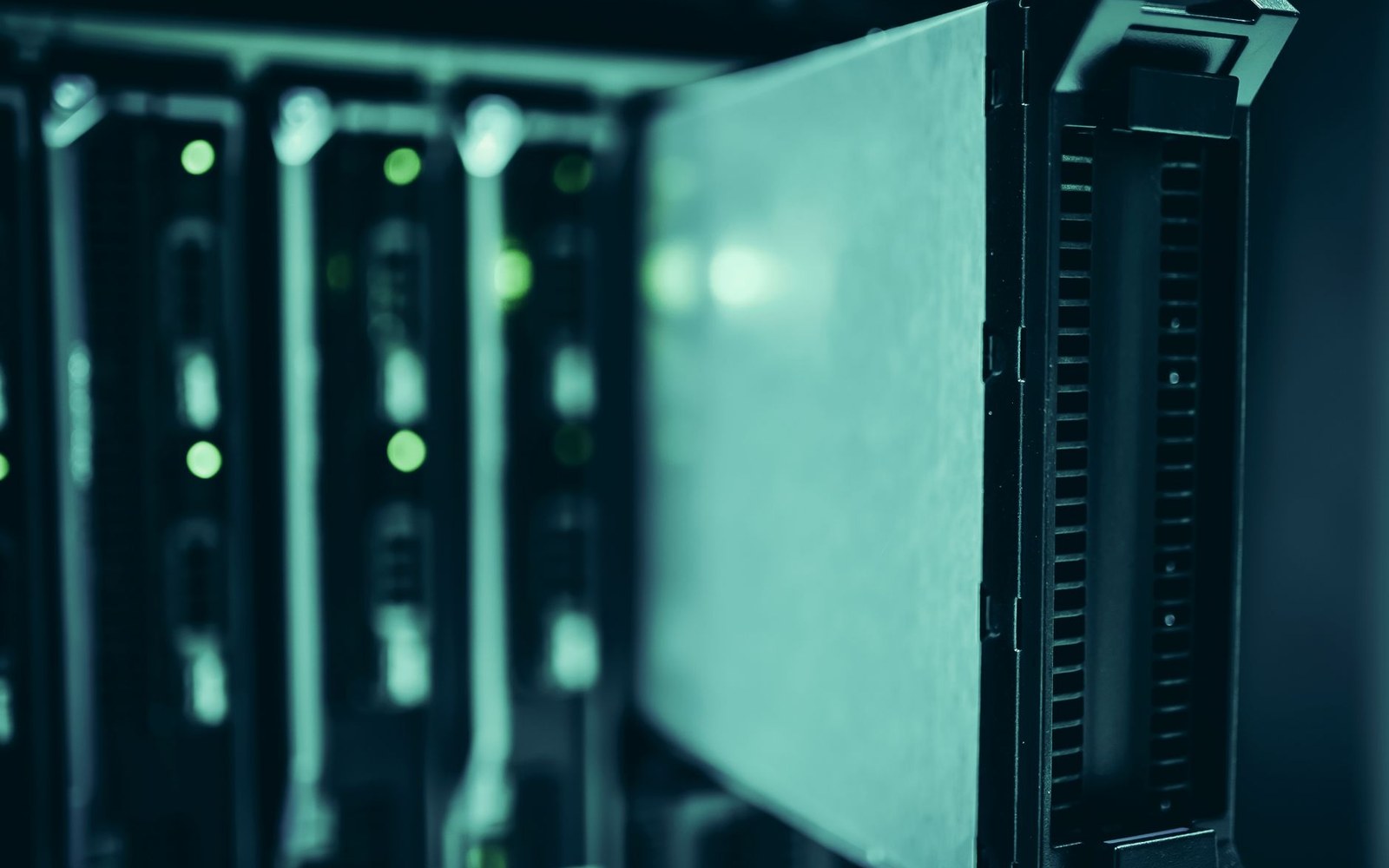 Close-up of a server drive bay partially removed from a data center rack