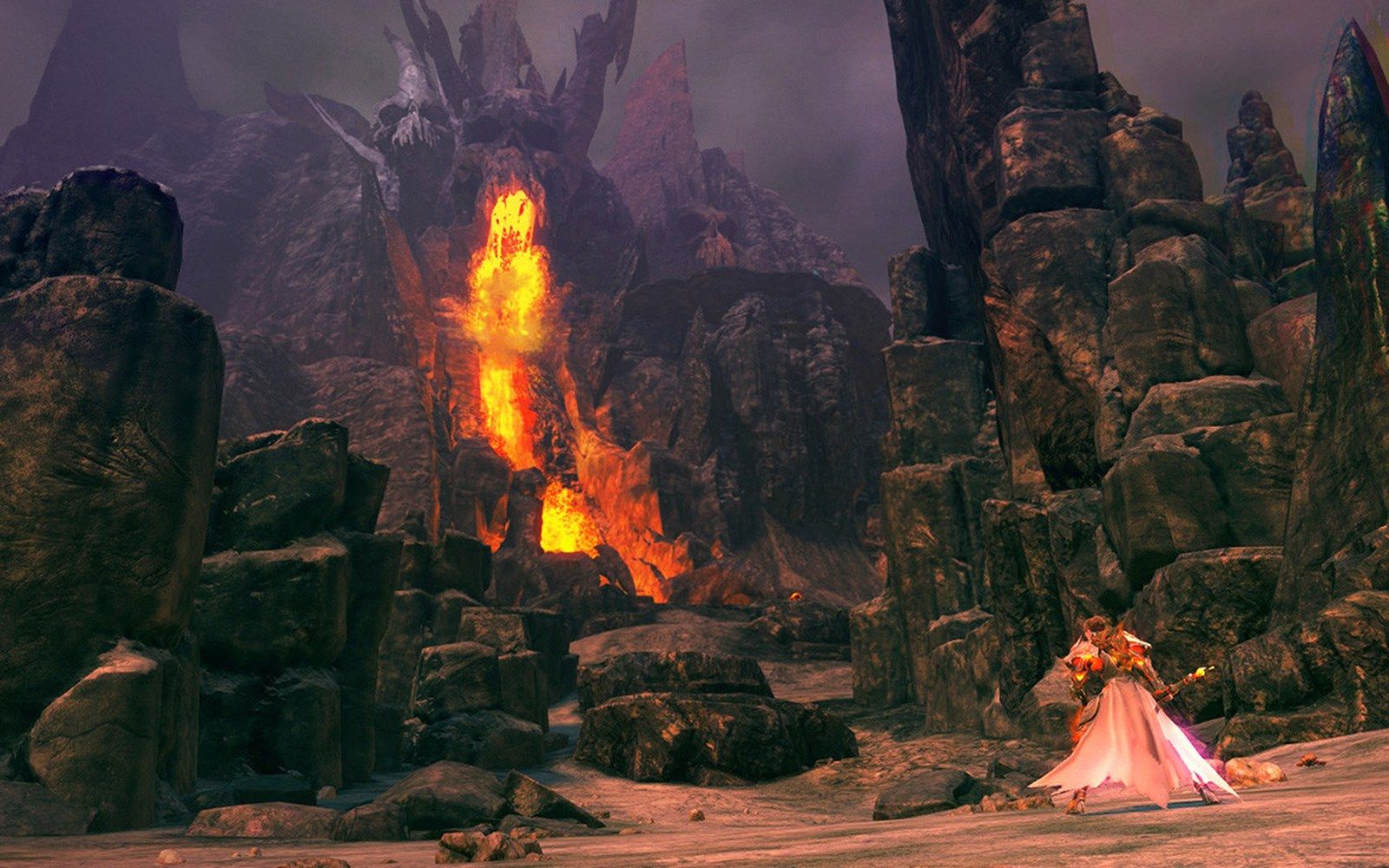 A robed character stands before a rocky canyon with erupting lava and jagged spires